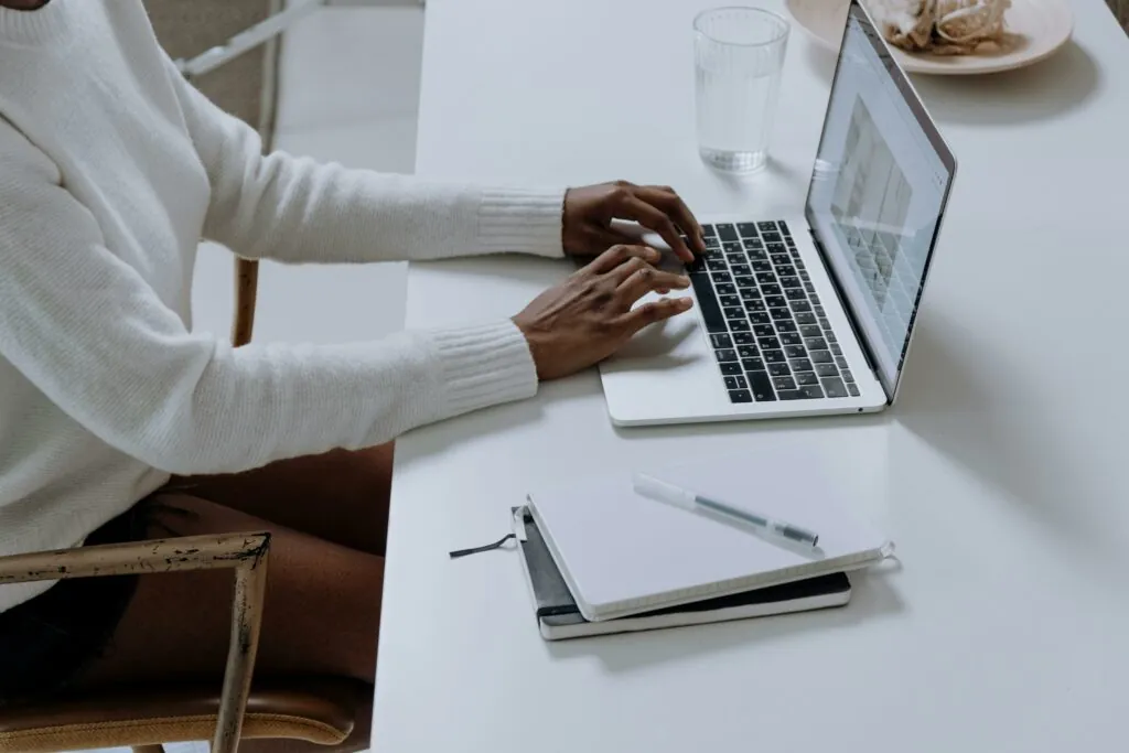 a person typing on a laptop