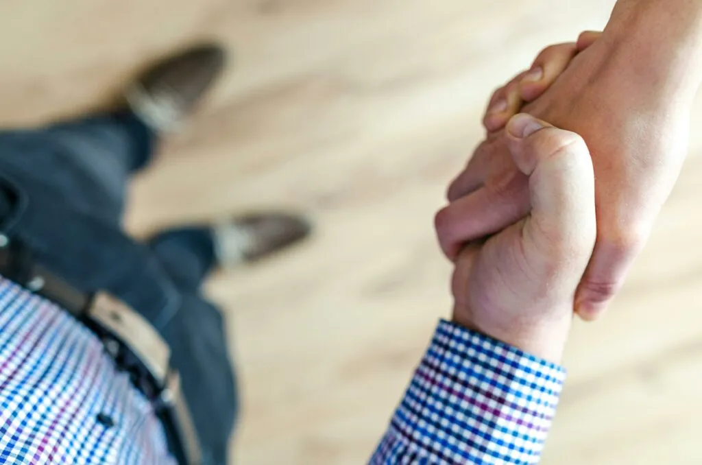 a close-up of hands holding each other