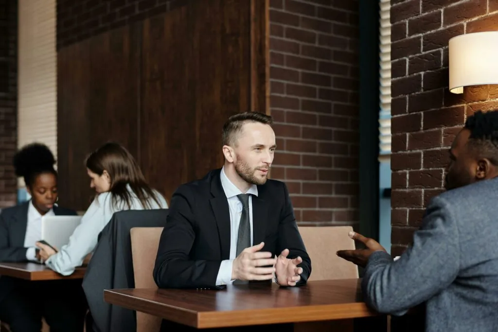 a man in a suit talking to a woman