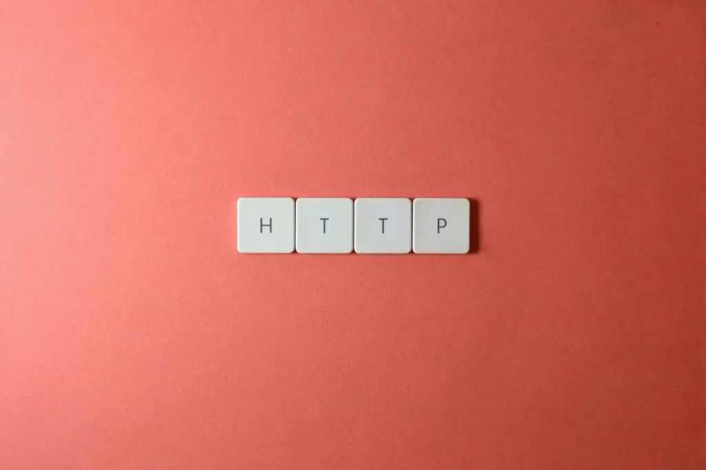 a group of white tiles with black letters http on a pink background